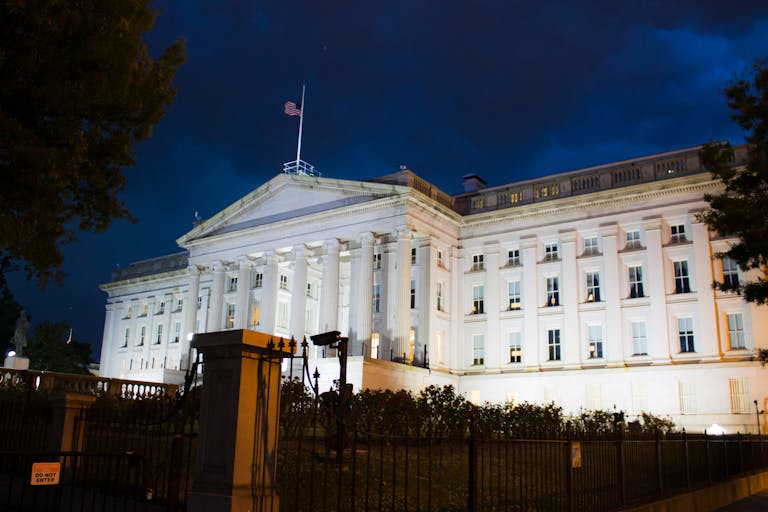 Stunning view of the U.S. Treasury Building illuminated against a twilight sky in Washington, DC.